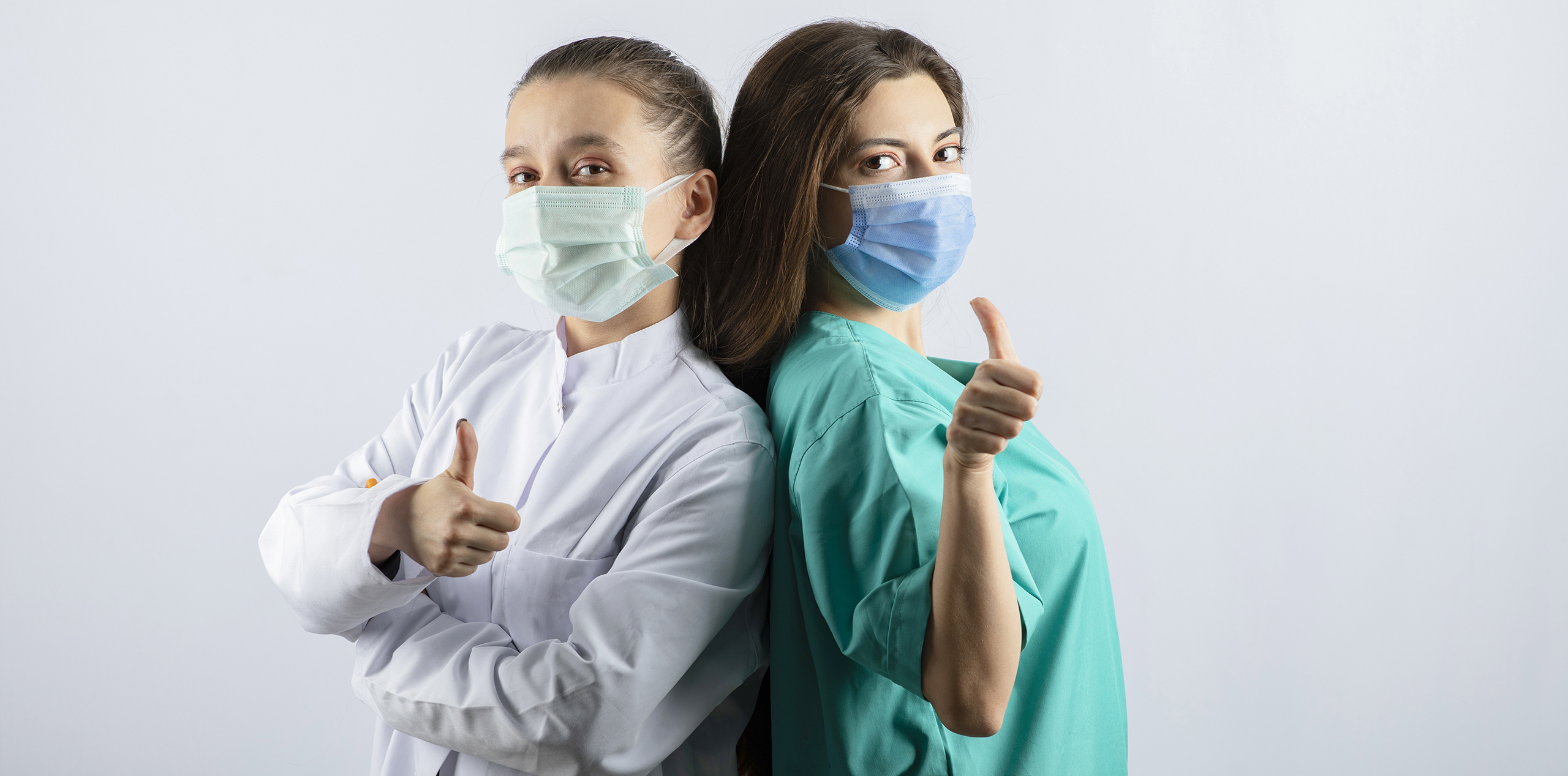 female-doctors-in-medical-masks-showing-thumbs-up